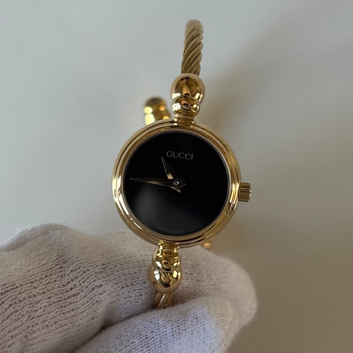 Gucci 1990s Black Round Dial Cable Gold-Plated Bangle Watch