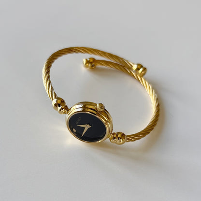 Gucci 1990s Black Round Dial Cable Gold-Plated Bangle Watch