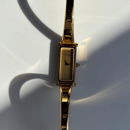 Gucci 1990s Rectangular Gold Dial Gold Plated Bangle Watch