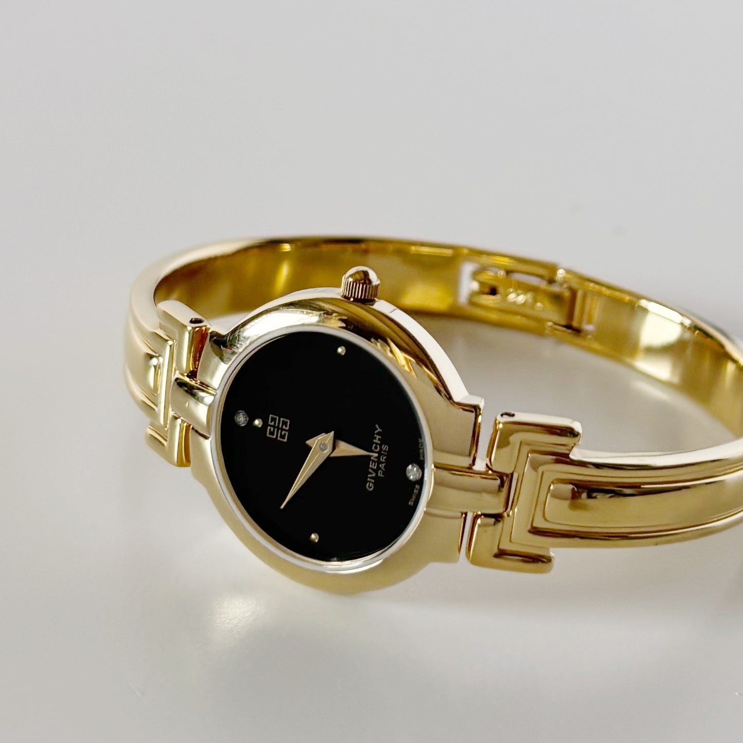 Givenchy 1990s Black Round Dial Gold Plated Bangle Watch