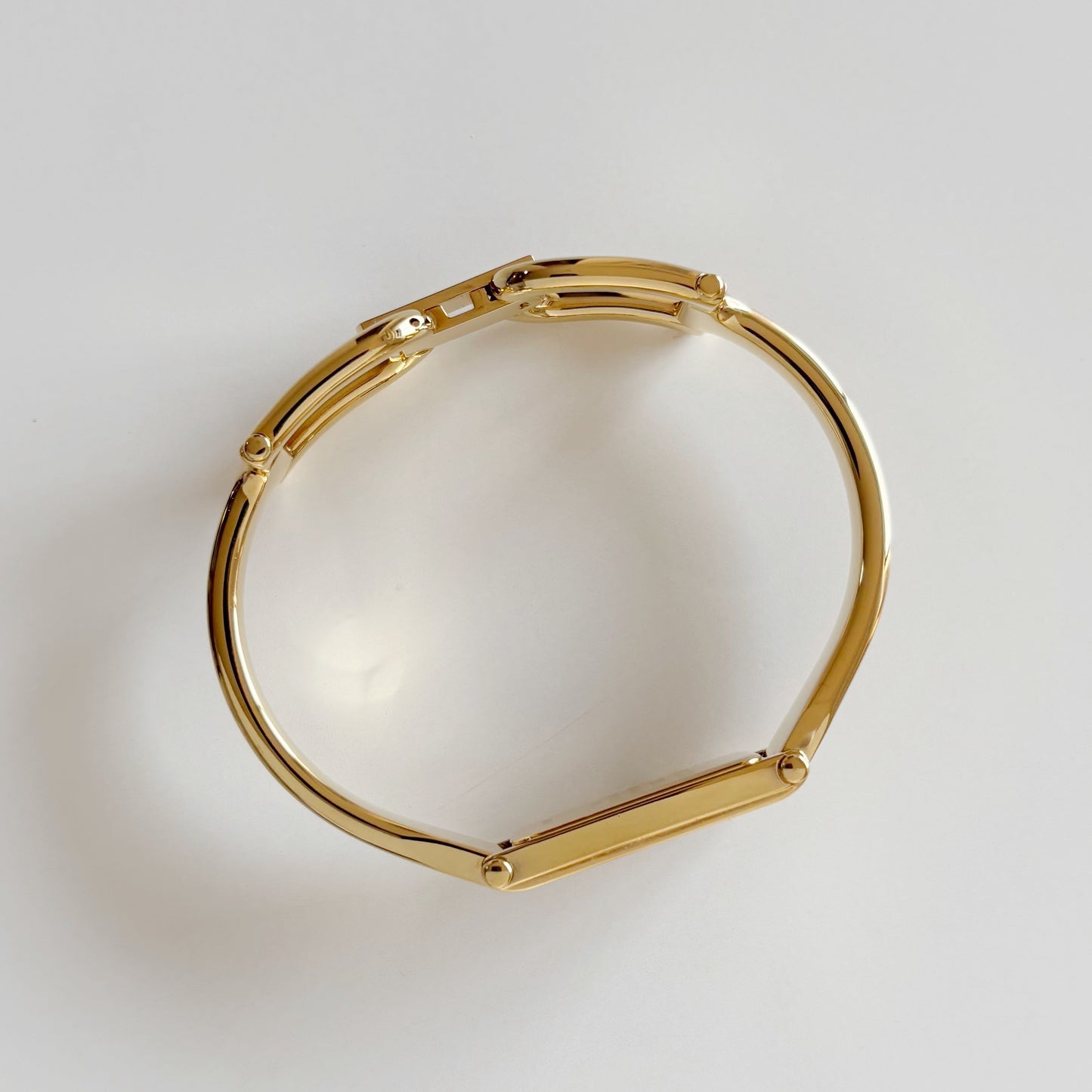 Gucci 1990s Rectangular Gold Dial Gold Plated Bangle Watch