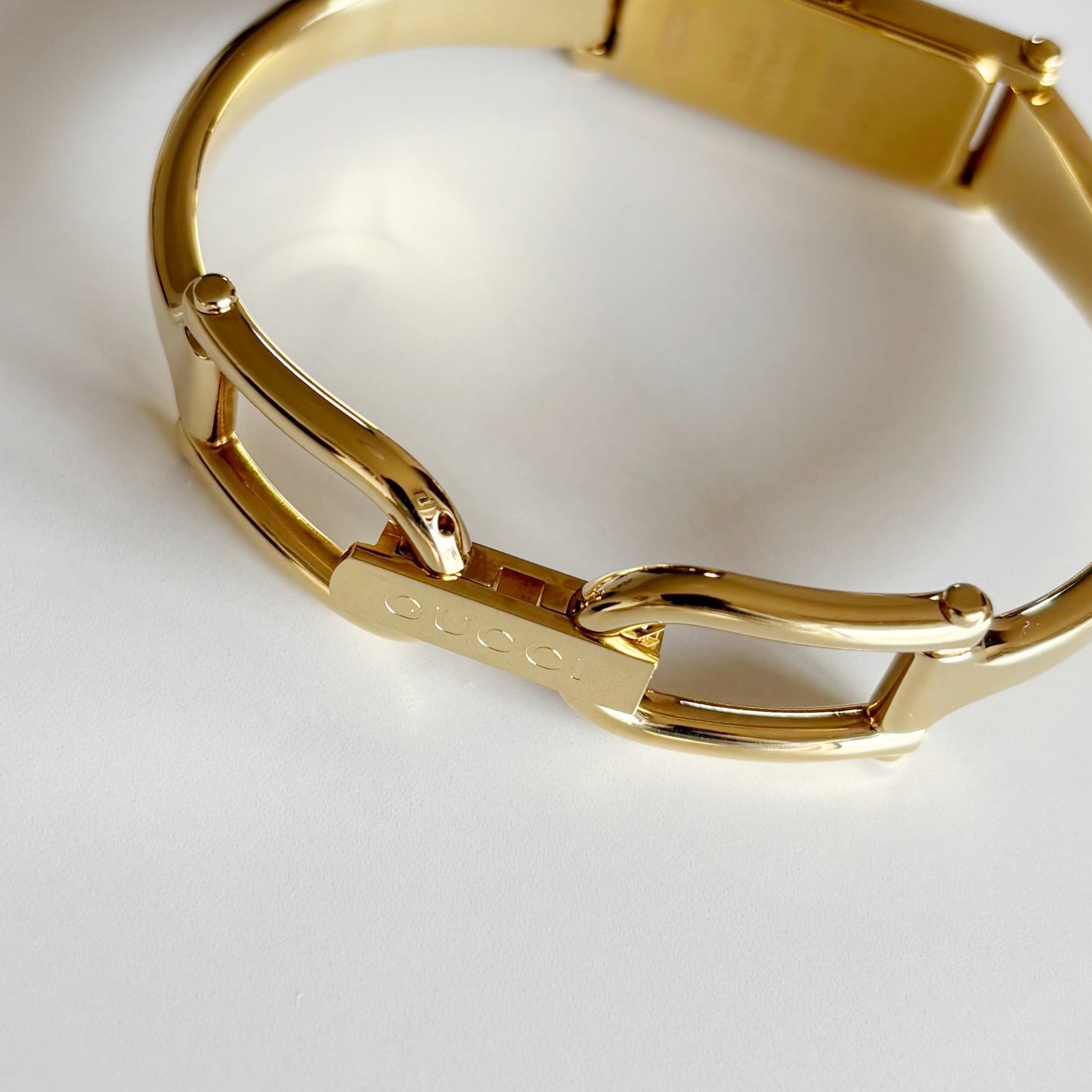 Gucci 1990s Rectangular Gold Dial Gold Plated Bangle Watch
