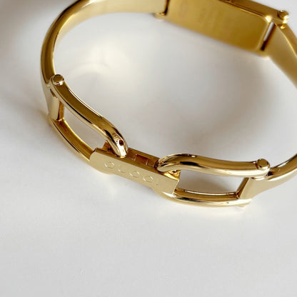 Gucci 1990s Rectangular Gold Dial Gold Plated Bangle Watch