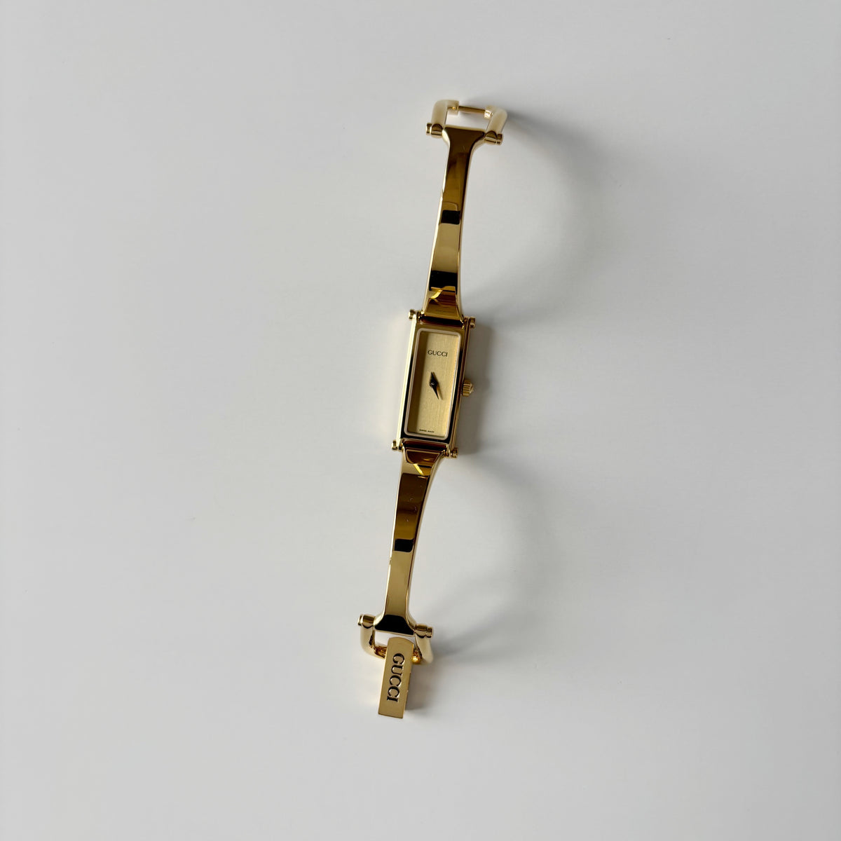 Gucci 1990s Rectangular Gold Dial Gold Plated Bangle Watch (Small)