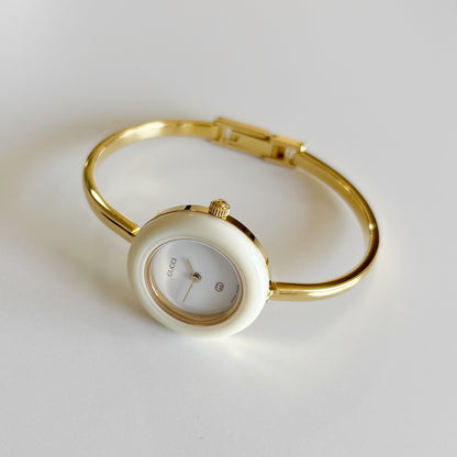 Gucci 1990s Interchangeable Bezel Gold Plated Bangle Watch with 12 bezels, case