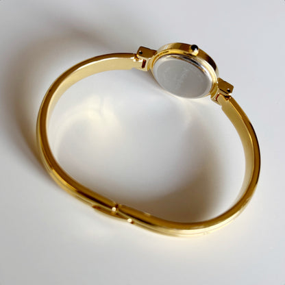 Yves Saint Laurent 1990s Black Round Dial Gold Plated Bangle Watch