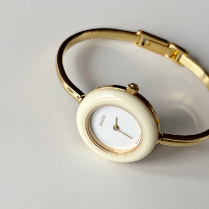 Gucci 1990s Interchangeable Bezel Gold Plated Bangle Watch with 12 bezels, case