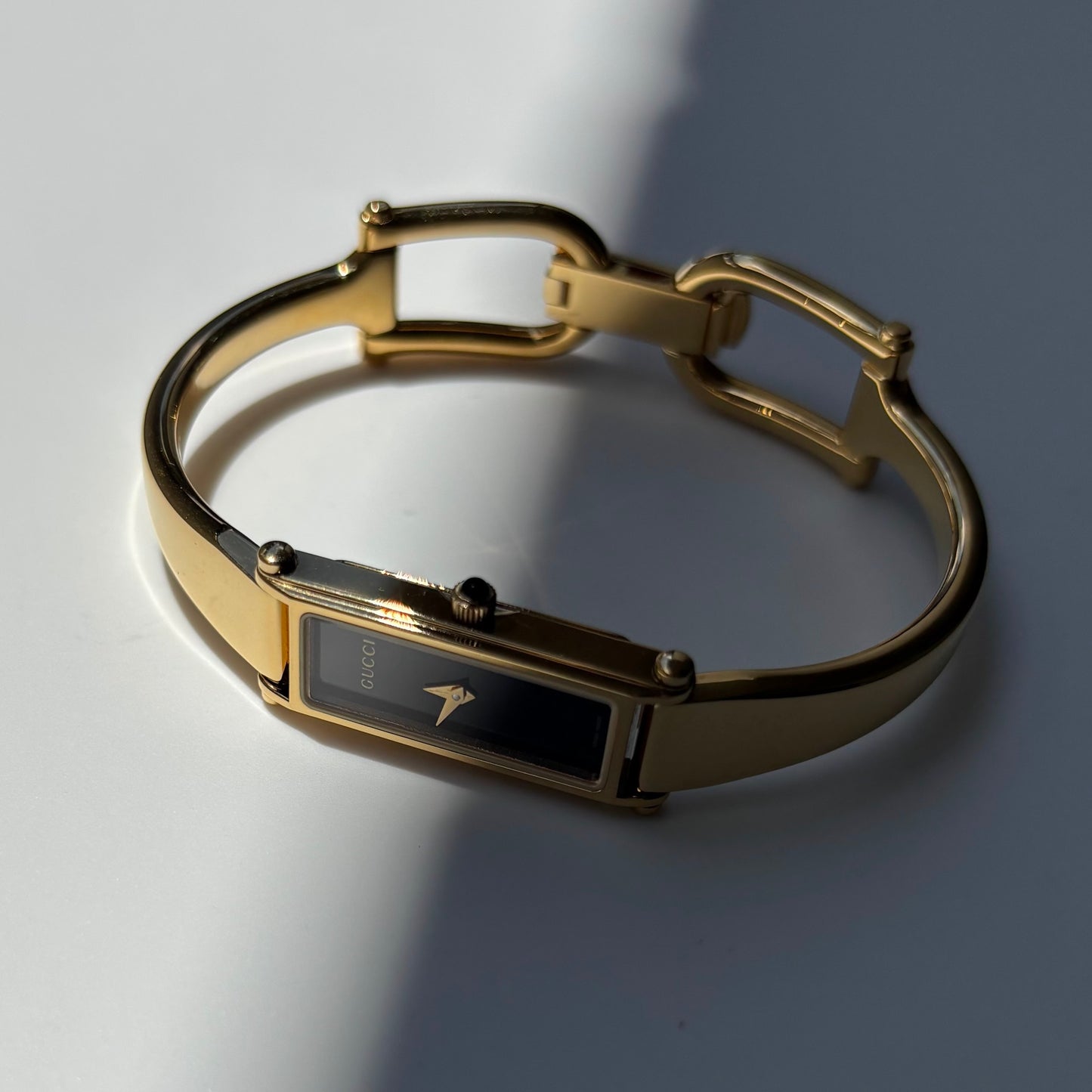 Gucci 1990s Black Rectangular Dial Gold Plated Bangle Watch