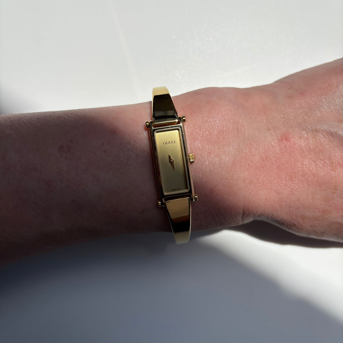 Gucci 1990s Rectangular Gold Dial Gold Plated Bangle Watch (Small)
