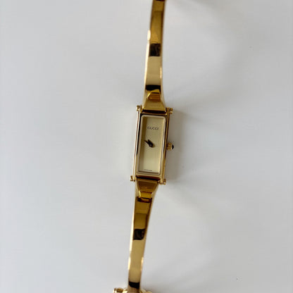 Gucci 1990s Rectangular Gold Dial Gold Plated Bangle Watch