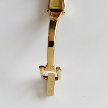 Gucci 1990s Rectangular Gold Dial Gold Plated Bangle Watch
