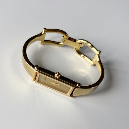 Gucci 1990s Rectangular Gold Dial Gold Plated Bangle Watch (Small)