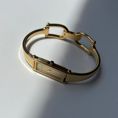 Gucci 1990s Rectangular Gold Dial Gold Plated Bangle Watch
