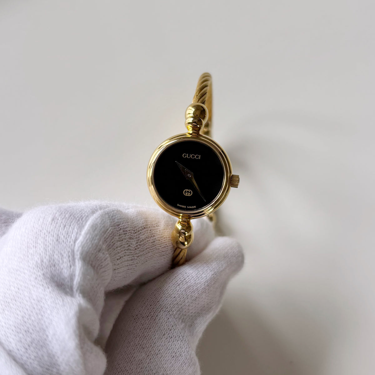 Gucci 1990s Black Round Dial Cable Gold Plated Bangle Watch
