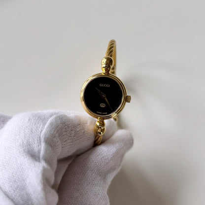 Gucci 1990s Black Round Dial Cable Gold Plated Bangle Watch