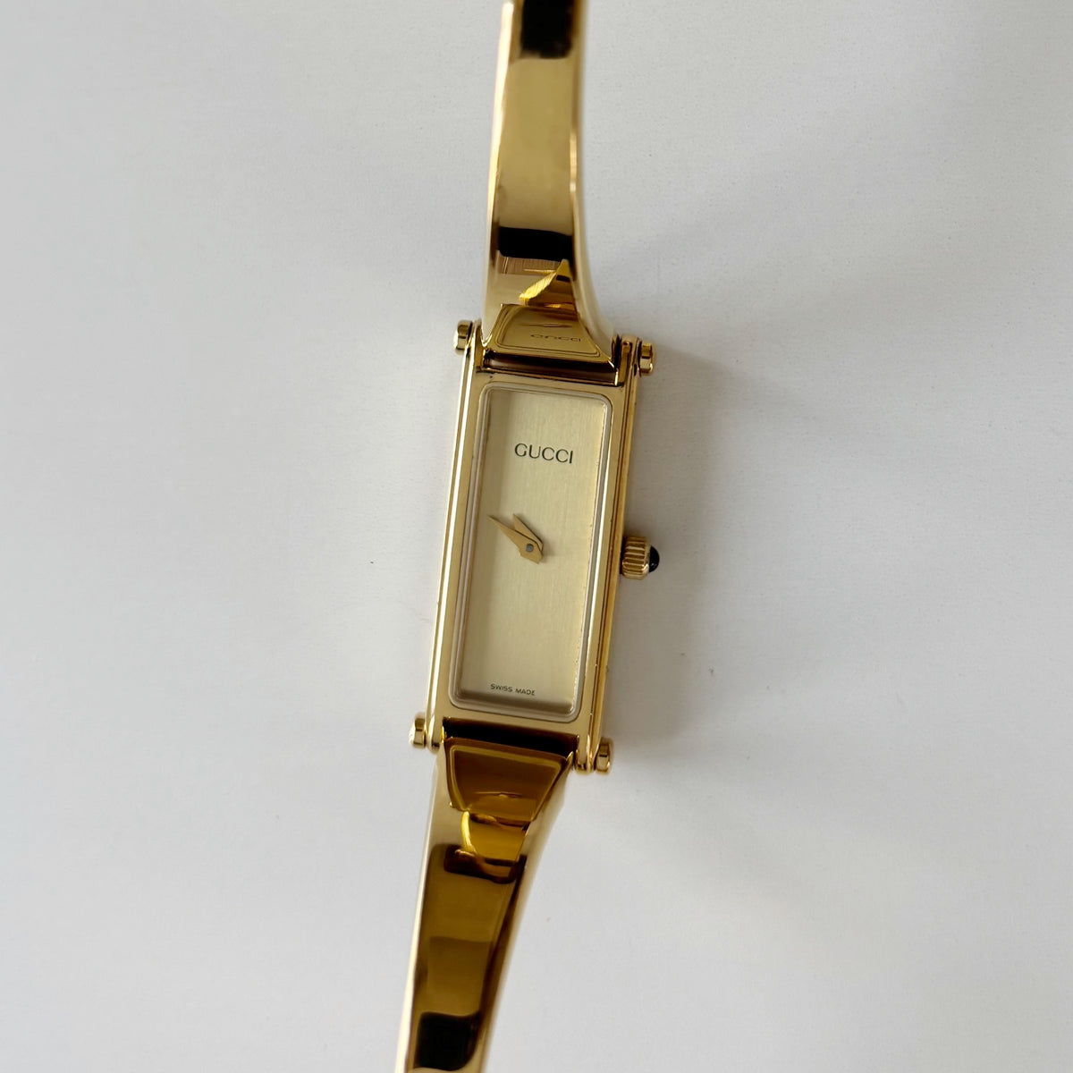 Gucci 1990s Rectangular Gold Dial Gold Plated Bangle Watch