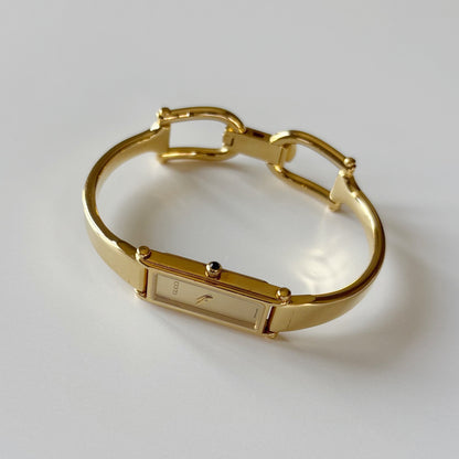 Gucci 1990s Rectangular Gold Dial Gold Plated Bangle Watch