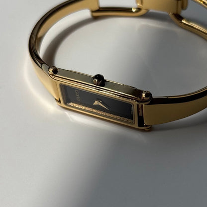 Gucci 1990s Black Rectangular Dial Gold Plated Bangle Watch