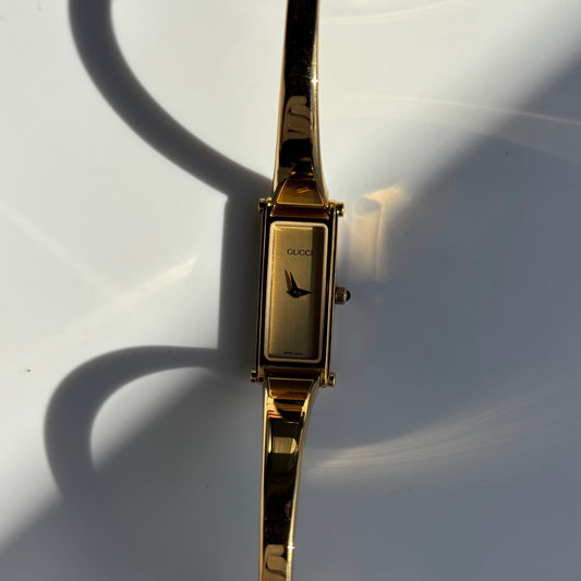 Gucci 1990s Rectangular Gold Dial Gold Plated Bangle Watch