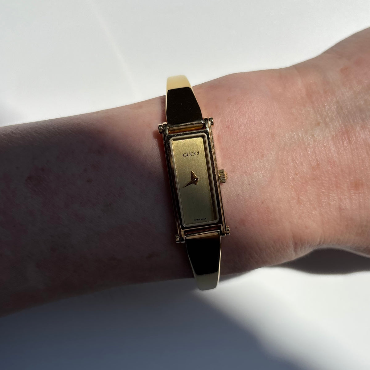 Gucci 1990s Gold Rectangular Dial Gold Plated Bangle Watch