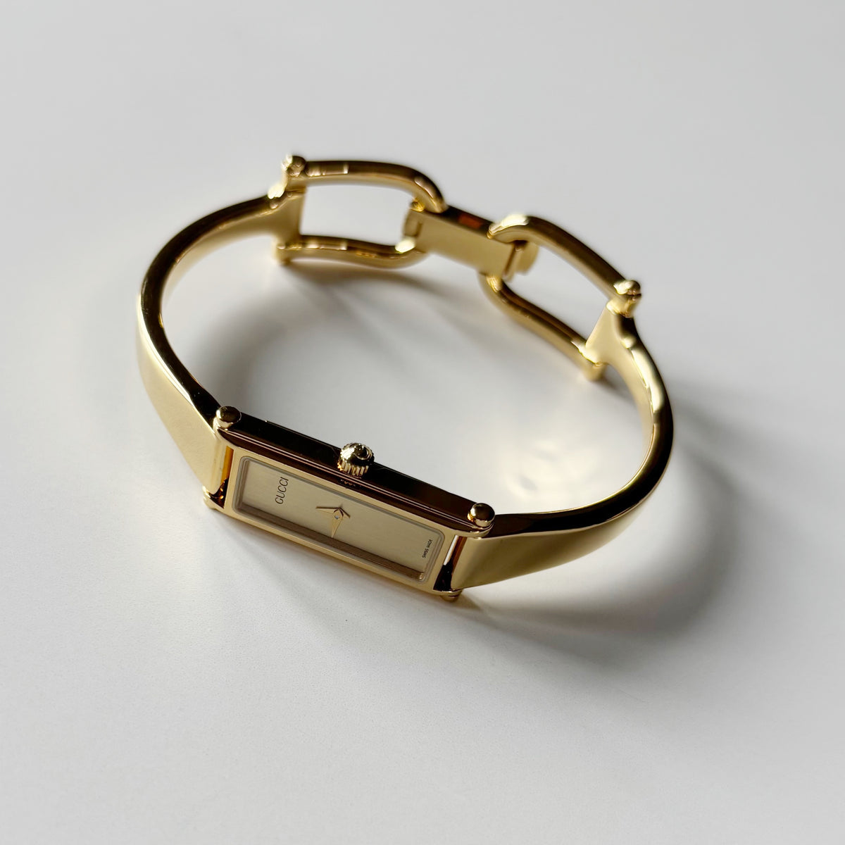 Gucci 1990s Gold Rectangular Dial Gold Plated Bangle Watch