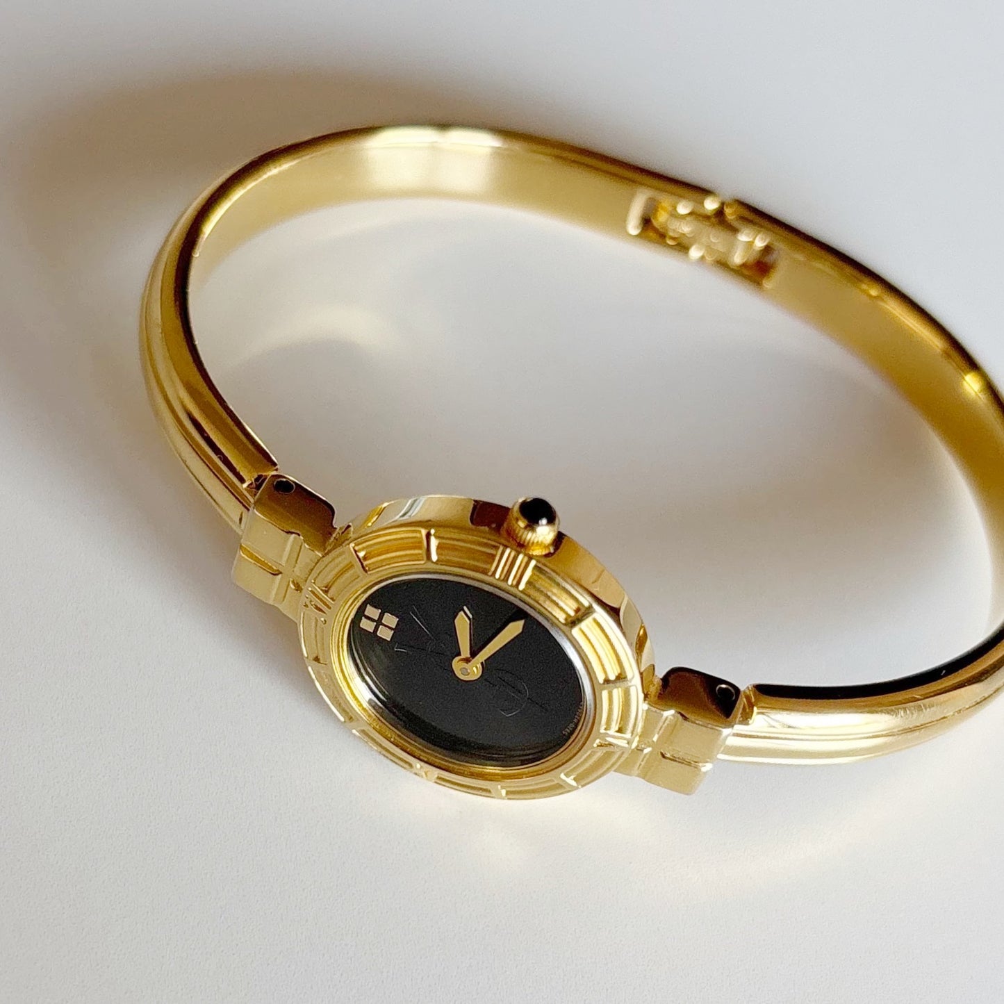 Yves Saint Laurent 1990s Black Round Dial Gold Plated Bangle Watch