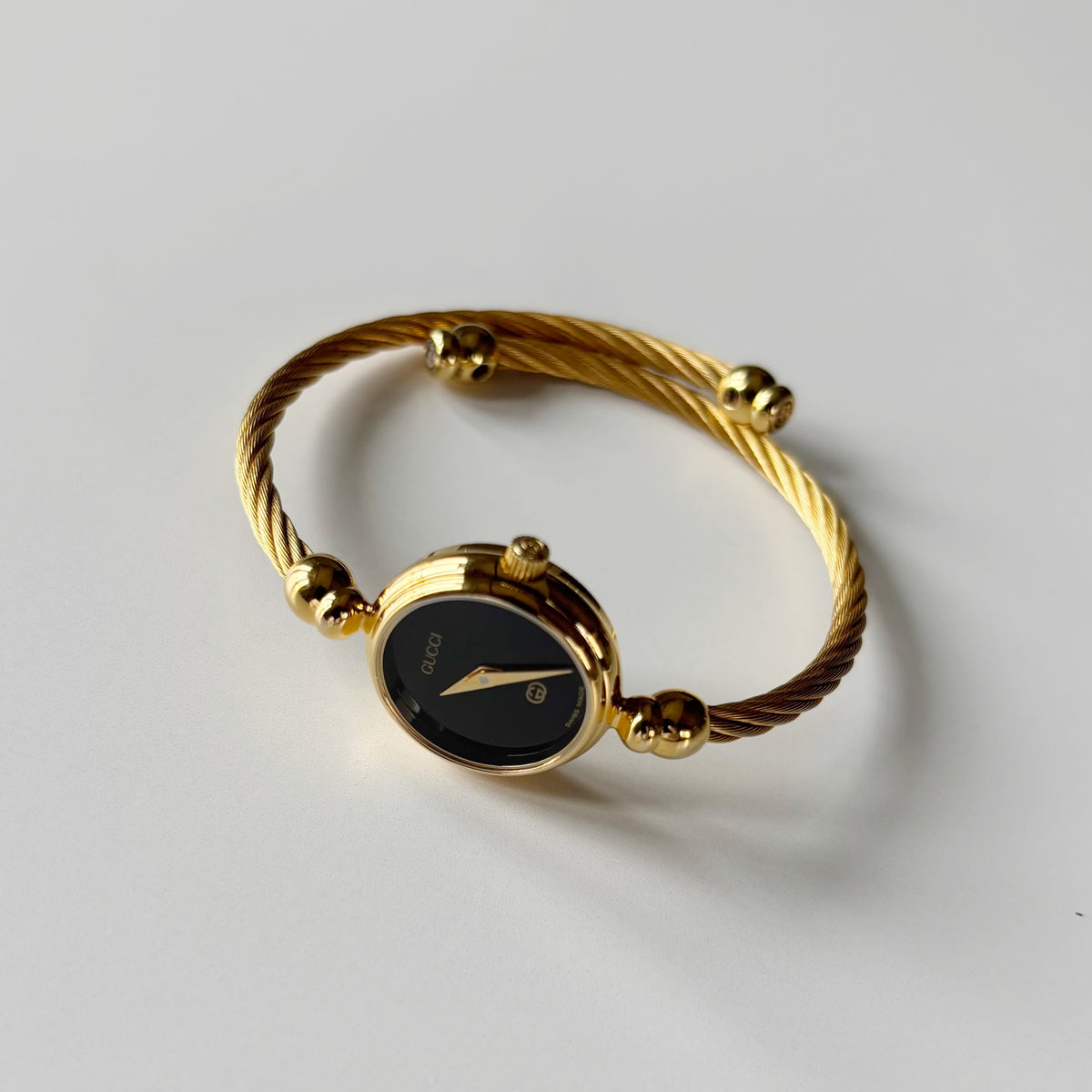 Gucci 1990s Black Round Dial Cable Gold Plated Bangle Watch