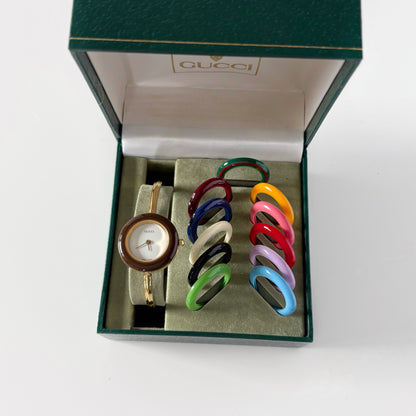 Gucci 1990s Interchangeable Bezel Gold Plated Bangle Watch with 12 bezels, case