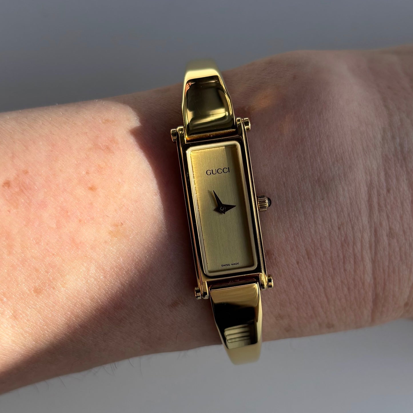 Gucci 1990s Rectangular Gold Dial Gold Plated Bangle Watch