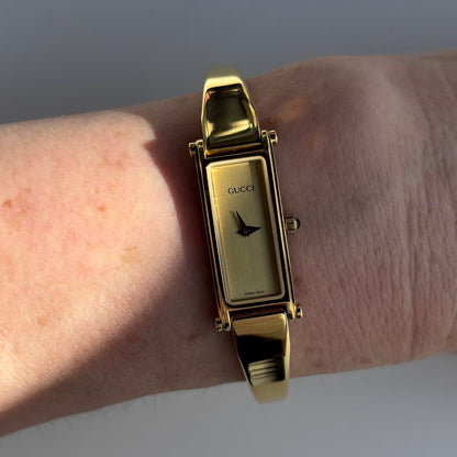 Gucci 1990s Rectangular Gold Dial Gold Plated Bangle Watch