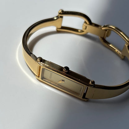 Gucci 1990s Rectangular Gold Dial Gold Plated Bangle Watch